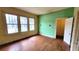 Green and yellow living room with hardwood floors, natural light, and a closet at 206 N Highland Ave, Winter Garden, FL 34787