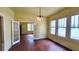 Bright living room with hardwood floors, ornate chandelier, and multiple windows offering plenty of natural light at 206 N Highland Ave, Winter Garden, FL 34787