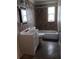 Updated bathroom featuring tile walls and a bathtub with shower, and a bright, white vanity at 2103 Mantilla Ave, Orlando, FL 32811