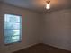 Cozy bedroom featuring carpet and a window with blinds for natural light at 2103 Mantilla Ave, Orlando, FL 32811