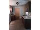 Kitchen featuring dark cabinets, laminate countertops and a stainless-steel sink at 2103 Mantilla Ave, Orlando, FL 32811