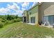 Backyard with lush lawn and partial patio at 214 Monroe Cir, Davenport, FL 33896