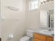 Bright and airy bathroom featuring a modern vanity, granite countertop, and fixtures at 214 Monroe Cir, Davenport, FL 33896