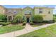 Townhouse exterior with manicured front lawn at 214 Monroe Cir, Davenport, FL 33896