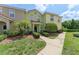 Townhouse exterior with manicured front lawn and walkway at 214 Monroe Cir, Davenport, FL 33896