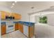 Functional kitchen with breakfast bar, and full appliances. Includes a great view of the living room space at 214 Monroe Cir, Davenport, FL 33896