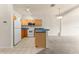 Well lit functional kitchen with stainless steel appliances and an open view to the living room at 214 Monroe Cir, Davenport, FL 33896