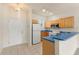 Functional kitchen with breakfast bar and white appliances and tile flooring offers plenty of space at 214 Monroe Cir, Davenport, FL 33896
