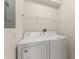 Convenient laundry area featuring a washer, dryer, and storage shelving. Easy access at 214 Monroe Cir, Davenport, FL 33896