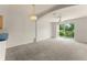 Spacious living area with neutral colors, ceiling fan, and sliding door to outside at 214 Monroe Cir, Davenport, FL 33896