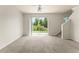 Bright living area with ceiling fan, sliding door, and staircase at 214 Monroe Cir, Davenport, FL 33896