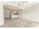 Open concept living and kitchen area with neutral paint and carpet at 214 Monroe Cir, Davenport, FL 33896
