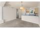 Bright living area with neutral tones, chandelier, and partial kitchen view at 214 Monroe Cir, Davenport, FL 33896