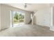 Living area with sliding door, ceiling fan, and staircase access at 214 Monroe Cir, Davenport, FL 33896
