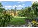 Backyard featuring lush green grass and landscaping with a wood fence at 225 Lewfield Cir # 225, Winter Park, FL 32792