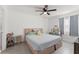Bedroom featuring a ceiling fan, a large bed and a window at 225 Lewfield Cir # 225, Winter Park, FL 32792