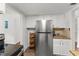 Kitchen featuring stainless steel fridge, granite counters, and white cabinets at 225 Lewfield Cir # 225, Winter Park, FL 32792
