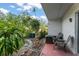 Outdoor patio area with seating and a fire pit, surrounded by lush landscaping at 225 Lewfield Cir # 225, Winter Park, FL 32792