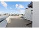 Spacious rooftop patio with bright white siding under blue sky, perfect for relaxing and entertaining at 2318 Addalia Aly, Orlando, FL 32804