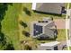 Aerial view of a house with solar panels on the roof, surrounded by green lawn and neighboring properties at 2340 Standing Rock Cir, Oakland, FL 34787