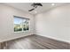 Clean and spacious bedroom featuring hardwood floors, neutral colors, and bright natural lighting at 2340 Standing Rock Cir, Oakland, FL 34787
