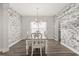 Charming dining room with modern chandelier, wood floors, and decorative stone walls at 2340 Standing Rock Cir, Oakland, FL 34787