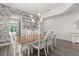 Bright dining room with wood floors, designer lighting, and elegant wall textures at 2340 Standing Rock Cir, Oakland, FL 34787