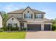 Beautiful two-story home with well-maintained landscaping and brick driveway, creating inviting curb appeal at 2340 Standing Rock Cir, Oakland, FL 34787