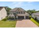 Stunning two-story home boasts a three-car garage and a beautifully paved driveway at 2340 Standing Rock Cir, Oakland, FL 34787