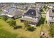 Aerial view of a modern home featuring a well-manicured lawn and solar panels at 2340 Standing Rock Cir, Oakland, FL 34787