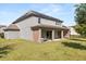 Two story home showcasing a covered patio perfect for outdoor entertainment or relaxation at 2340 Standing Rock Cir, Oakland, FL 34787