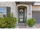 Elegant front door with decorative wreath, stone accents, and charming landscaping at 2340 Standing Rock Cir, Oakland, FL 34787