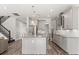 Modern kitchen features gray cabinets, stainless steel appliances, an island with granite countertops, and sleek hardwood floors at 2340 Standing Rock Cir, Oakland, FL 34787