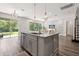 Spacious kitchen island with granite countertop and modern pendant lighting at 2340 Standing Rock Cir, Oakland, FL 34787