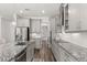 Gray kitchen features modern appliances, granite countertops, and wood floors at 2340 Standing Rock Cir, Oakland, FL 34787