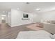 Spacious living room showcasing a TV, neutral-toned decor, hardwood floors and a comfortable sofa at 2340 Standing Rock Cir, Oakland, FL 34787