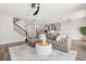 Cozy living room showcasing a gray sofa, staircase, and kitchen at 2340 Standing Rock Cir, Oakland, FL 34787