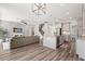Open concept living area showcasing a stone accent wall, sofa, and kitchen island at 2340 Standing Rock Cir, Oakland, FL 34787