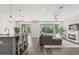 Open concept living area with stone accent wall, fireplace, and sliding doors to the backyard at 2340 Standing Rock Cir, Oakland, FL 34787