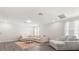 Open living room featuring hardwood floors, modern lighting, and neutral decor at 2340 Standing Rock Cir, Oakland, FL 34787