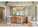Bathroom vanity with decorative framed mirror, granite counters, and a stone tiled floor at 2357 Alaqua Dr, Longwood, FL 32779