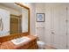 Bathroom with ceramic tile shower, and wood framed mirror at 2357 Alaqua Dr, Longwood, FL 32779