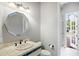 A bathroom featuring a unique mirror and tile countertop at 2357 Alaqua Dr, Longwood, FL 32779