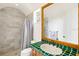 Bathroom featuring marble tiled shower, green tile countertops, and plenty of natural light at 2357 Alaqua Dr, Longwood, FL 32779