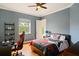 Bedroom with hardwood floors, ceiling fan, and large window at 2357 Alaqua Dr, Longwood, FL 32779
