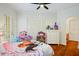 Bright bedroom with hardwood floors, shutters, and double doors leading to the outside at 2357 Alaqua Dr, Longwood, FL 32779