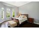 Cozy bedroom features hardwood floors, natural light, and a neutral color palette at 2357 Alaqua Dr, Longwood, FL 32779