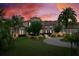 Elegant exterior view of home showcasing lush lawn and mature trees in a serene setting at 2357 Alaqua Dr, Longwood, FL 32779