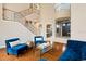 Living room with hardwood floors, view into dining room, grand foyer, and staircase with iron railings at 2357 Alaqua Dr, Longwood, FL 32779
