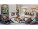 Spacious living room flowing into a kitchen with a stone fireplace, seating, and hardwood floors at 2357 Alaqua Dr, Longwood, FL 32779